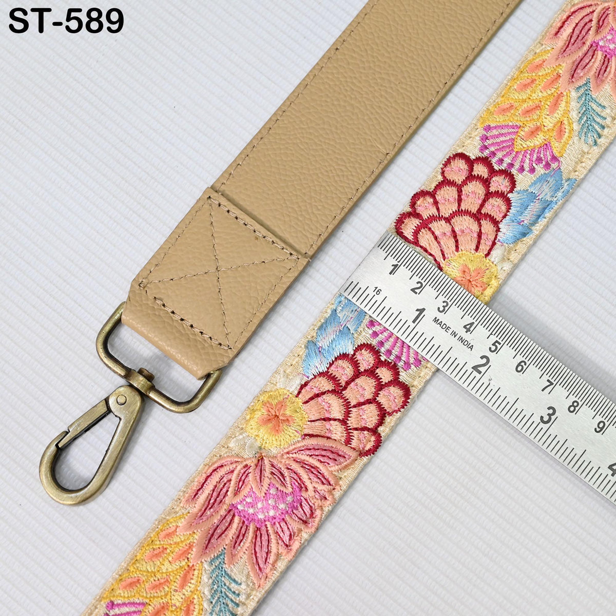 a beige strap with a floral embroidered pattern, and a ruler is placed next to it, indicating the strap's length.
