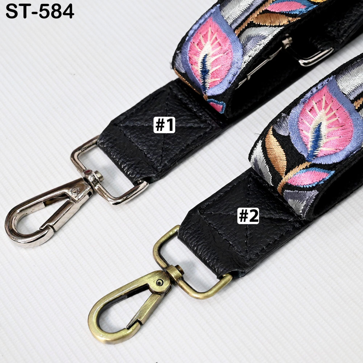 two straps with different designs, one with a floral pattern and the other with a metallic pattern.