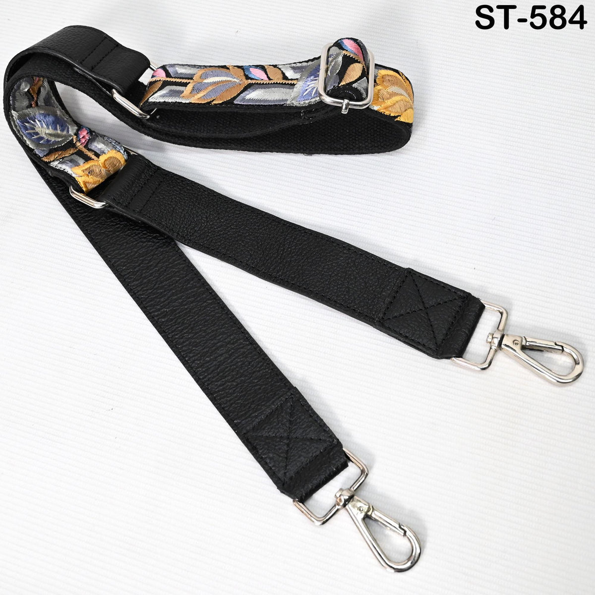 A black leather strap with metal hooks and buckles, designed for carrying items.