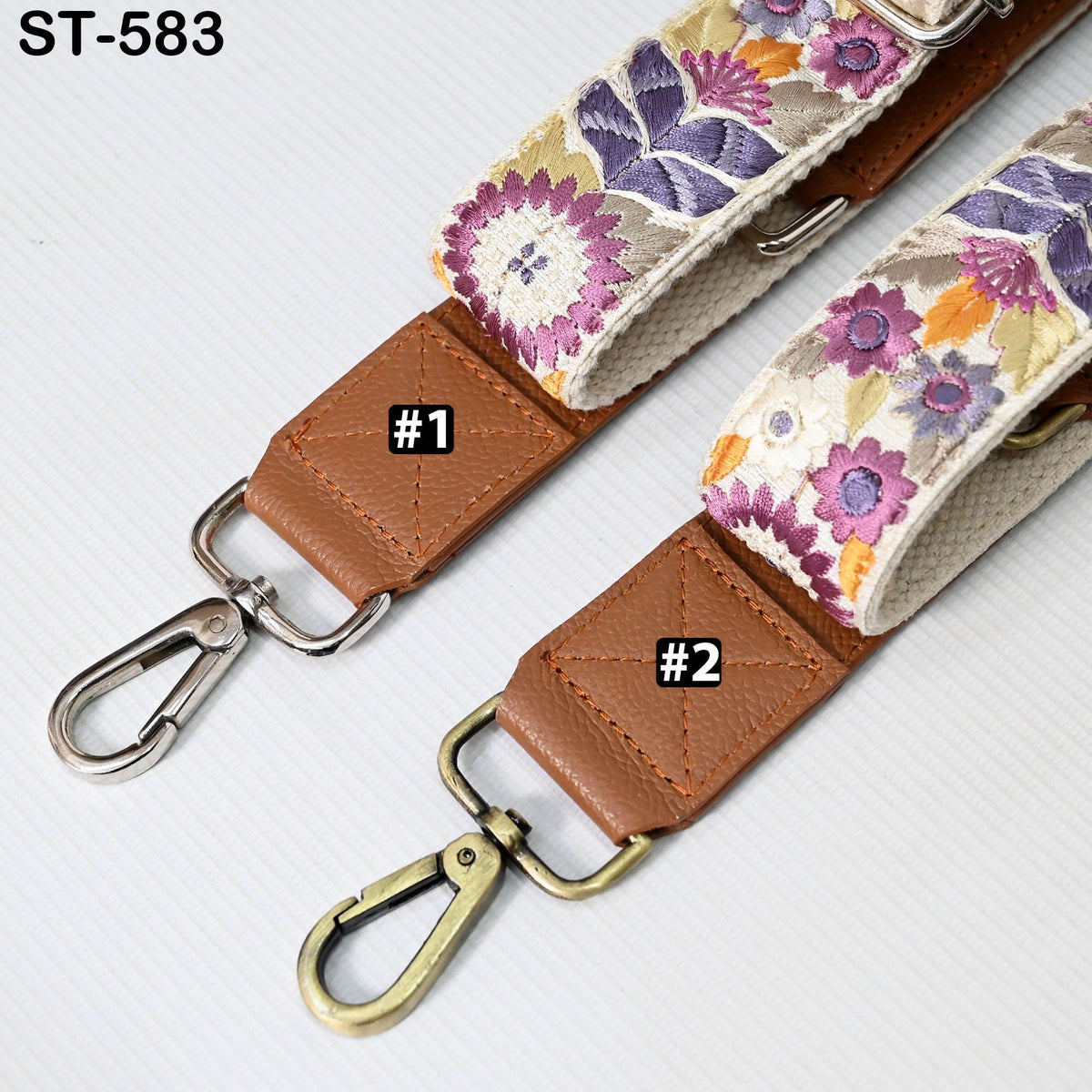 two straps with floral patterns, one with a brown leather strap and the other with a beige strap. The straps have metal hooks and buckles, and there are labels indicating the number 1 and 2.