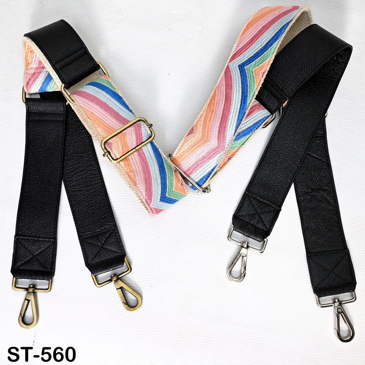 two leather straps with metal hooks, one black and one colorful striped, placed side by side on a white background.