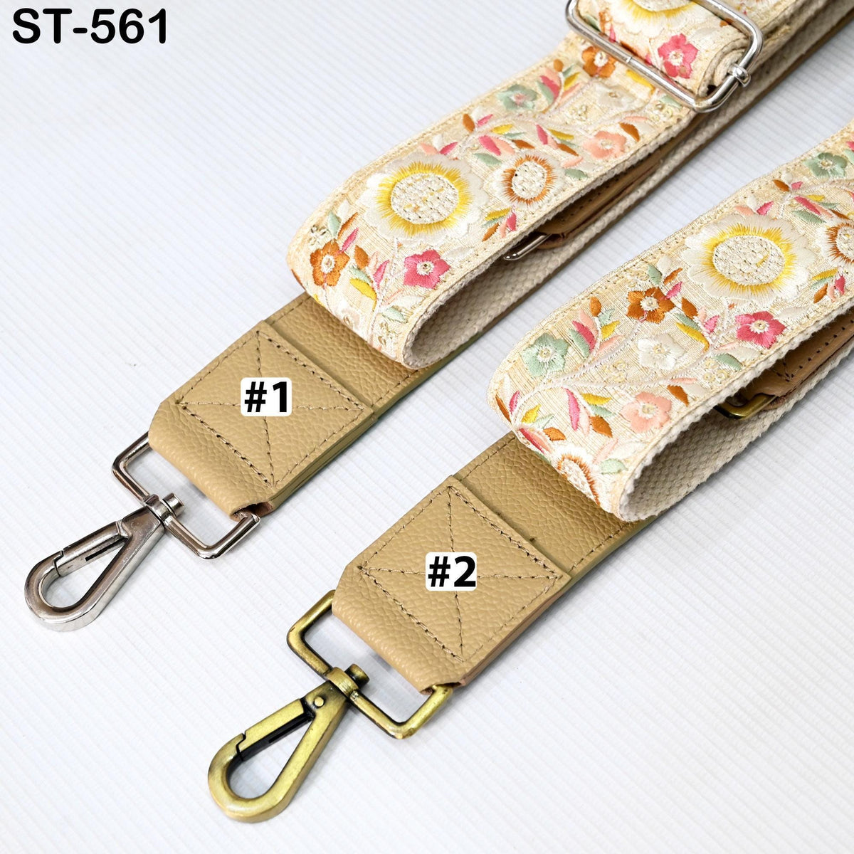 two straps with floral patterns, one with a beige color and the other with a floral print. The straps have metal hooks and buckles, and there are labels on them indicating the number one and number two.