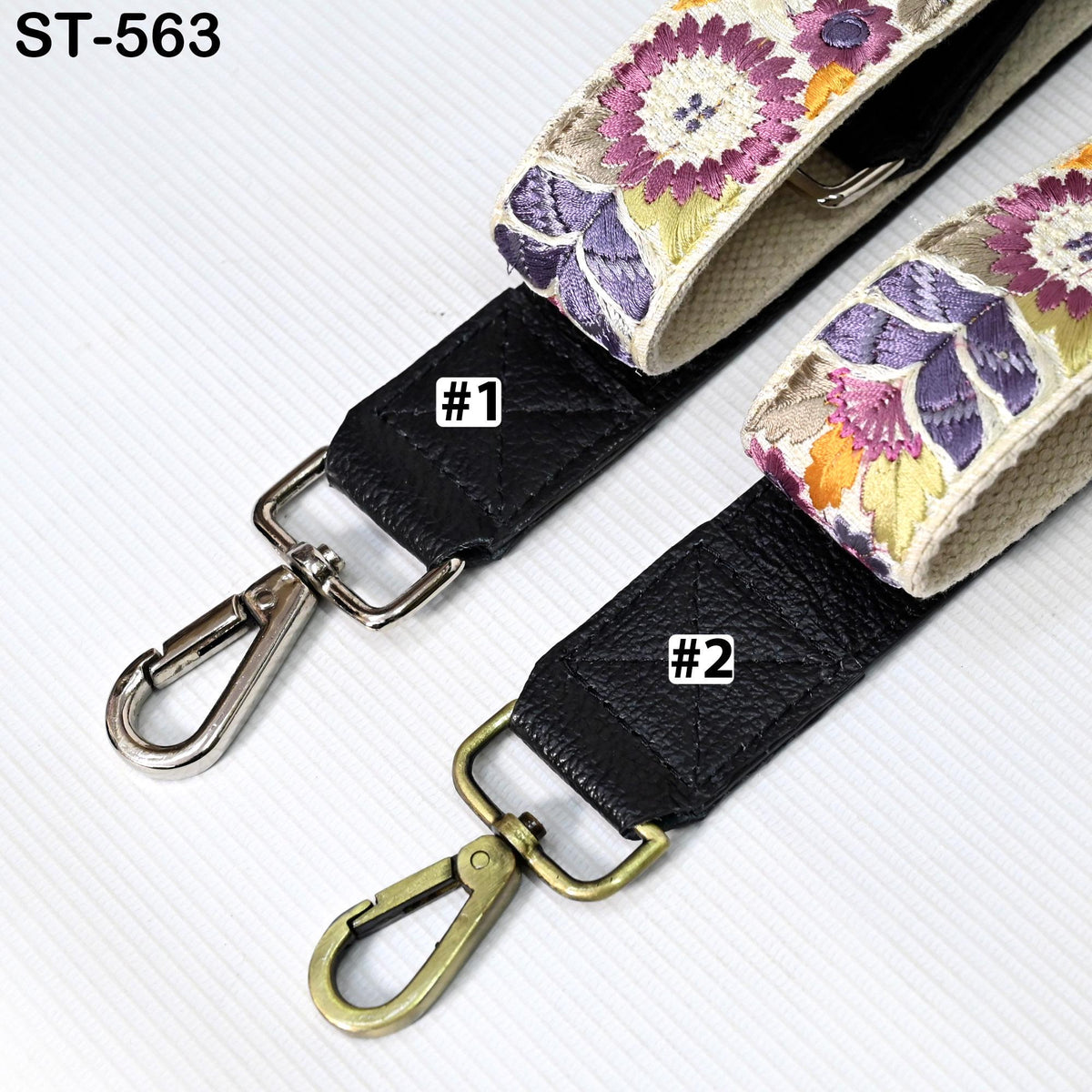 two straps with floral patterns, one with a black strap and the other with a beige strap. The straps have metal hooks and buckles, and there are labels indicating the number 1 and 2 on each strap.