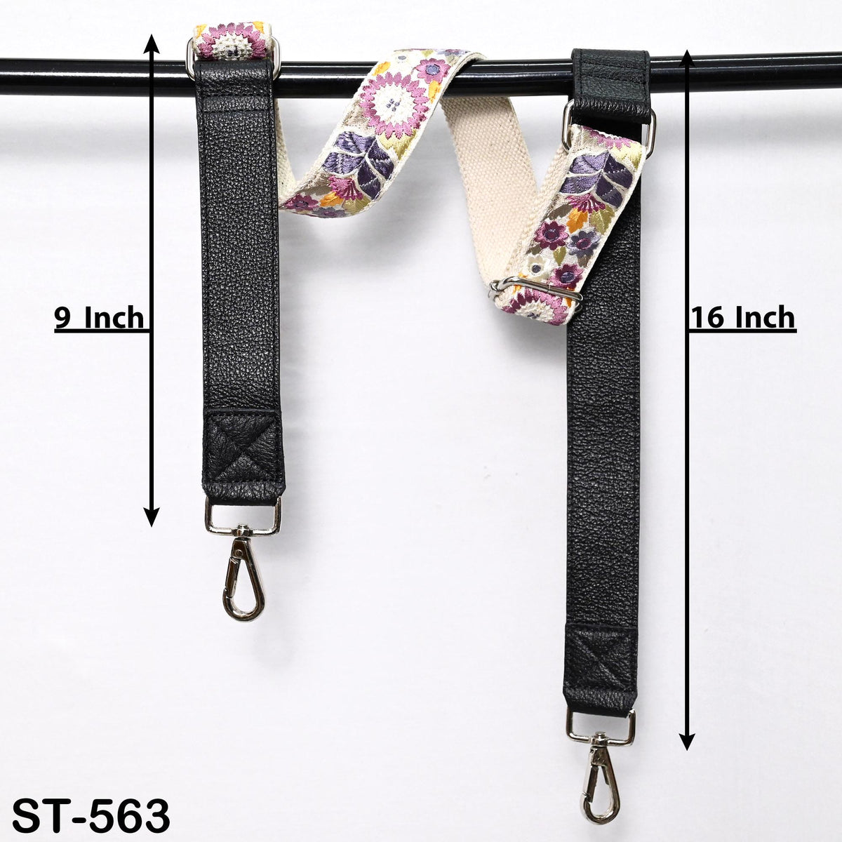two black leather straps with floral patterns, hanging on a black bar. The straps are 9 inches and 16 inches long, respectively.