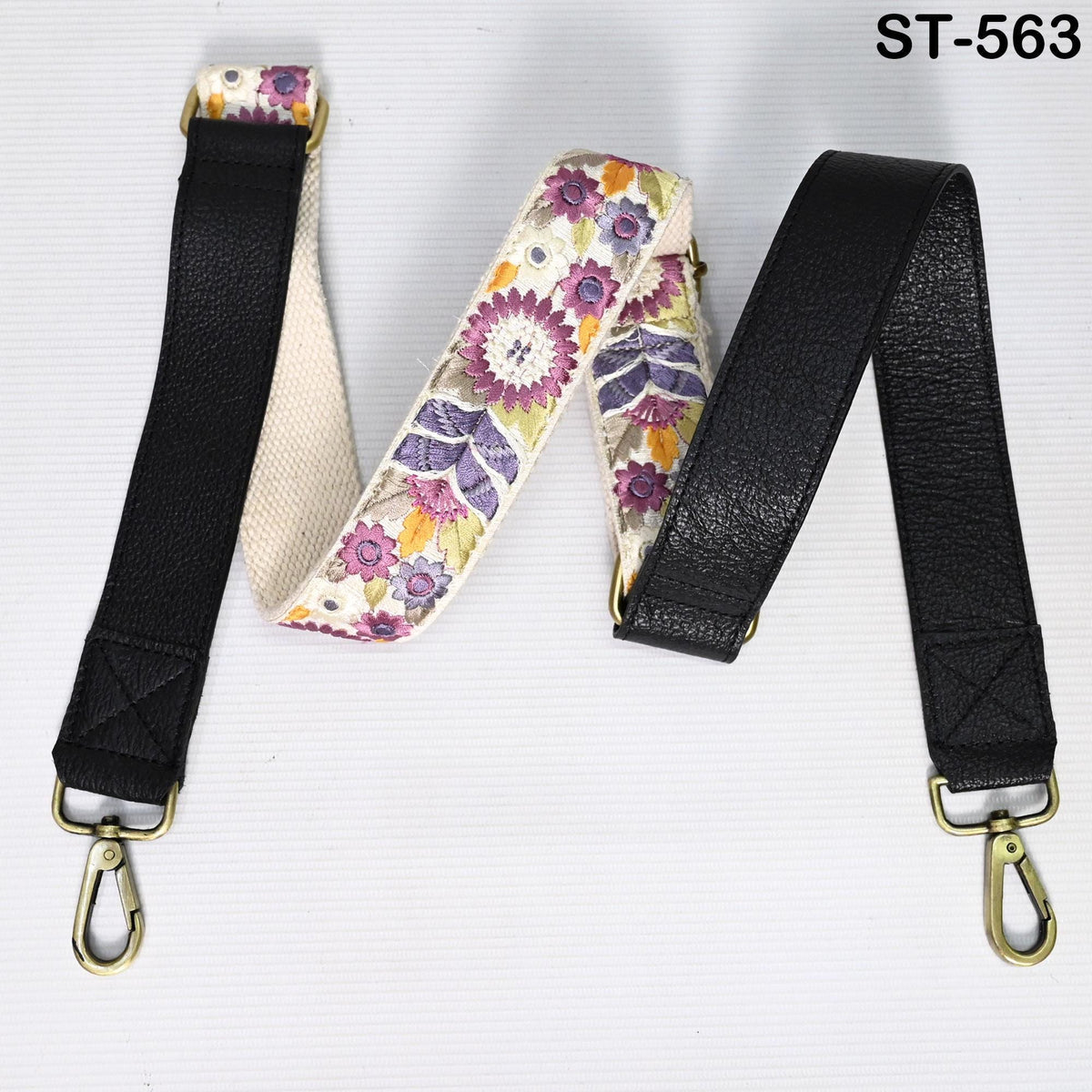 two straps, one with a floral pattern and the other with a black leather texture, both attached to a black leather strap.