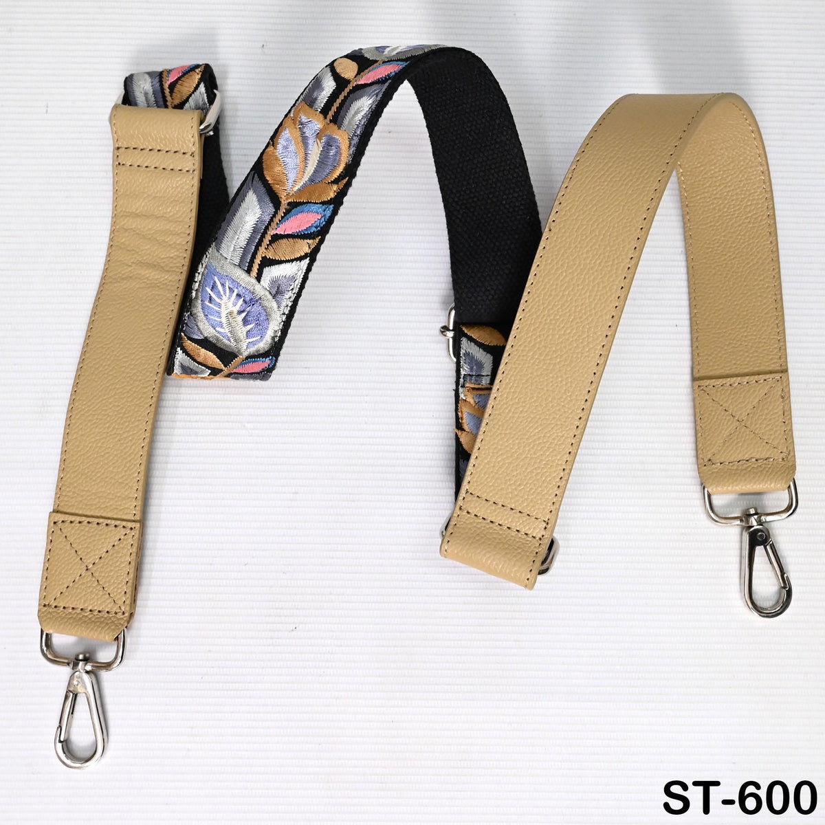 A beige leather strap with a floral pattern and a metal hook attachment, designed for use as a crossbody bag strap.