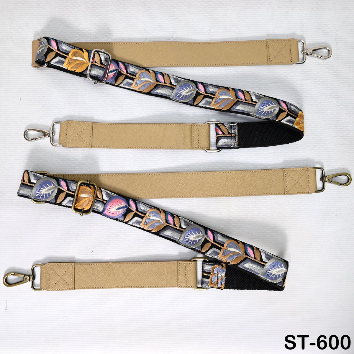 a collection of beige and floral-patterned straps with metal buckles, arranged on a white background.