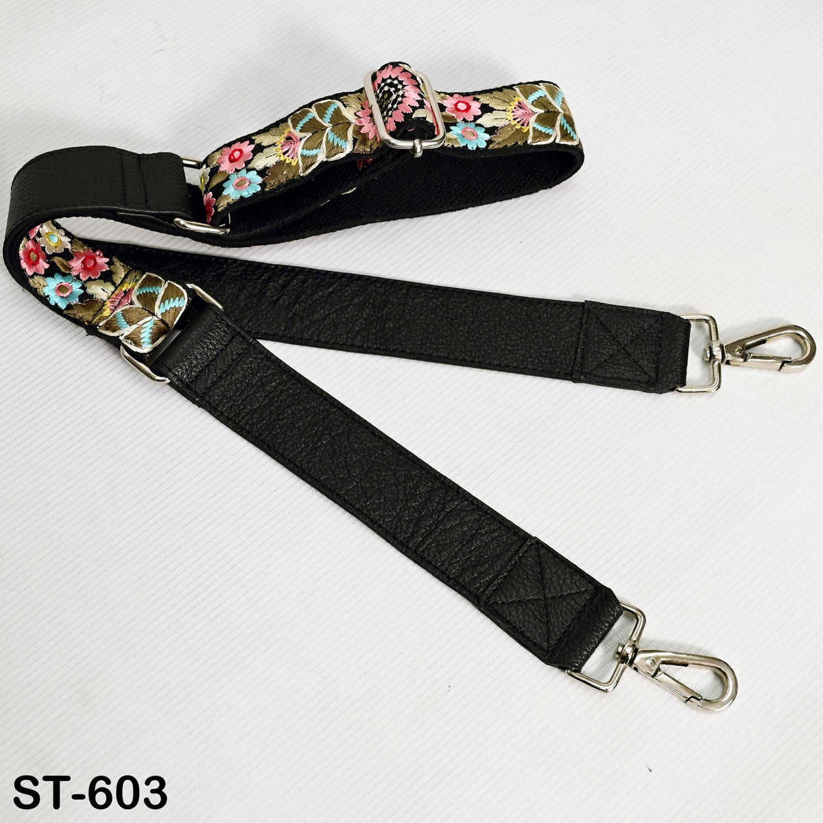 A black strap with a floral pattern and metal hooks, labeled as ST-603.